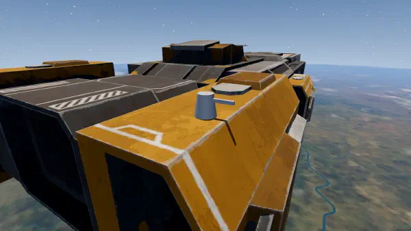 A small grey point defence turret, extended, on top of the carrier's orange stern pod.