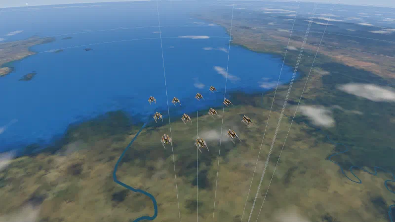 A squadron of twelve Strikers in three chevrons, high over a coastline, on the approach.