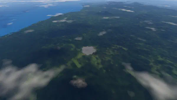 Forested ranges of West Sumatra from about 30 km up, the small grey town of Bukittinggi in the middle and the coast at upper left.
